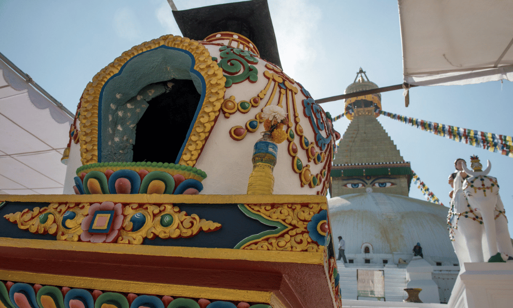 a statue infront of boudha stupa